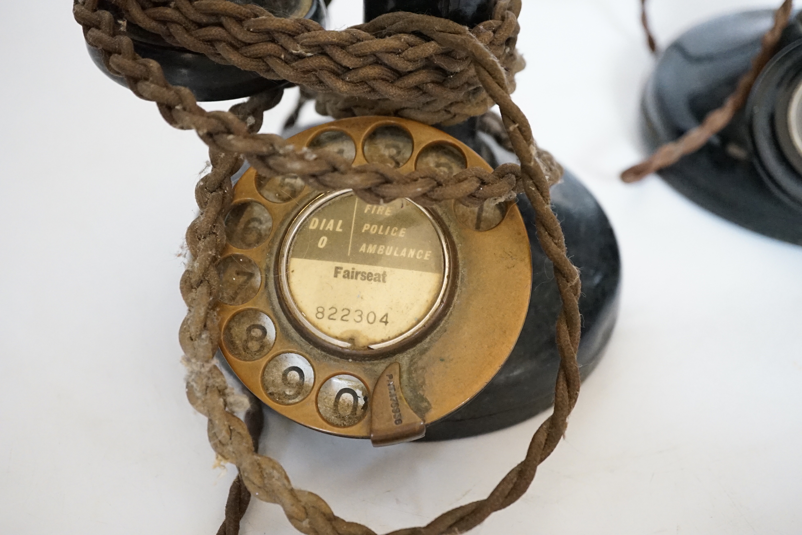 Two early black Bakelite pillar telephones, 31cm high